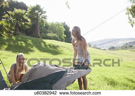 Two young females friends unwrapping tent View Large Photo Image Stock Image - Two young females friends unwrapping tent. Fotosearch