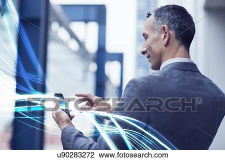 Waves of blue light and businessman using touchscreen on smartphone View Large Photo Image Stock Image - Waves of blue light and businessman using touchscreen on smartphone. Fotosearch