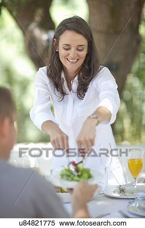 Wife serving salad to husband View Large Photo Image Stock Photography - Wife serving salad to husband. Fotosearch