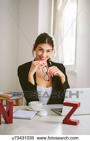 Woman at desk with laptop View Large Photo Image Stock Photography - Woman at desk with laptop. Fotosearch