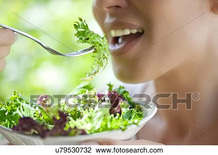 Woman eating salad View Large Photo Image Stock Image - Woman eating salad. Fotosearch