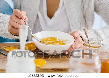 Woman having muesli and fruit View Large Photo Image Stock Image - Woman having muesli and fruit. Fotosearch