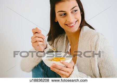 Woman having muesli and fruit View Large Photo Image Stock Photo - Woman having muesli and fruit. Fotosearch