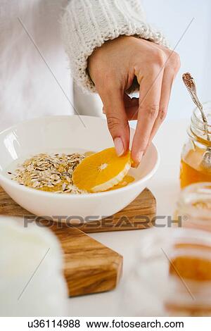 Stock Photo - Woman having muesli and fruit. Fotosearch