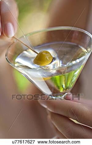Woman holding glass of cocktail View Large Photo Image Stock Photo - Woman holding glass of cocktail. Fotosearch
