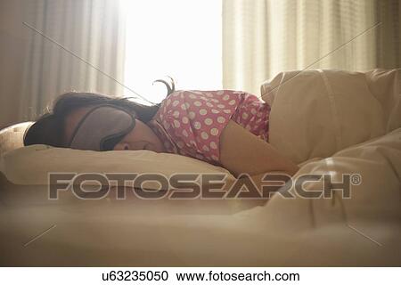 Woman in eye mask asleep in bed View Large Photo Image Stock Image - Woman in eye mask asleep in bed. Fotosearch