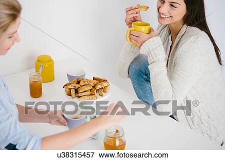 Women having honey drink and biscuits View Large Photo Image Stock Photo - Women having honey drink and biscuits. Fotosearch