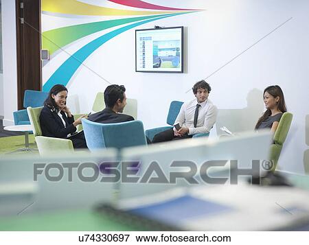 Stock Photo - Workers relaxing in modern office. Fotosearch