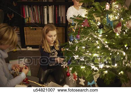 Young brother and sister decorating christmas tree View Large Photo Image Stock Photo - Young brother and sister decorating christmas tree. Fotosearch