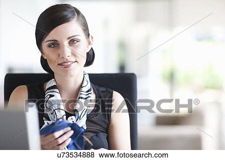 Young businesswoman cleaning her spectacles View Large Photo Image Stock Photo - Young businesswoman cleaning her spectacles. Fotosearch