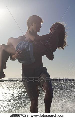 Young couple by seaside View Large Photo Image Stock Image - Young couple by seaside. Fotosearch