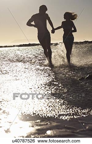 Young couple by seaside View Large Photo Image Stock Photograph - Young couple by seaside. Fotosearch