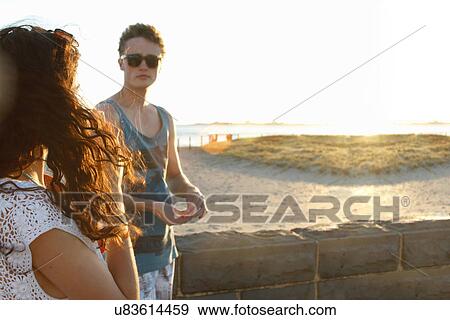 Young couple by wall, Port Melbourne, Melbourne, Australia View Large Photo Image Stock Photo - Young couple by wall, Port Melbourne, Melbourne, Australia. Fotosearch