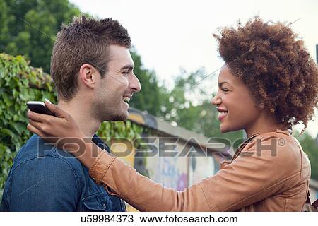 Young couple chatting face to face View Large Photo Image Stock Image - Young couple chatting face to face. Fotosearch
