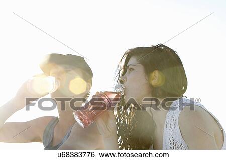 Young couple drinking soft drinks View Large Photo Image Stock Photograph - Young couple drinking soft drinks. Fotosearch