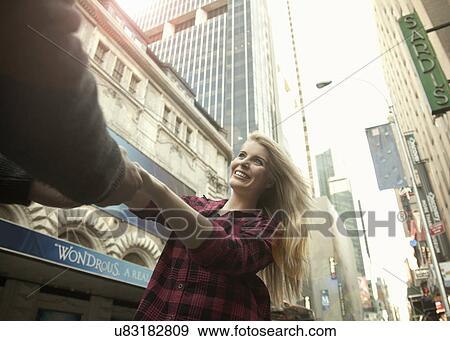 Stock Photo - Young couple holding hands, New York City, USA. Fotosearch