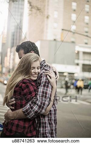Stock Image - Young couple hugging on street, New York City, USA. Fotosearch