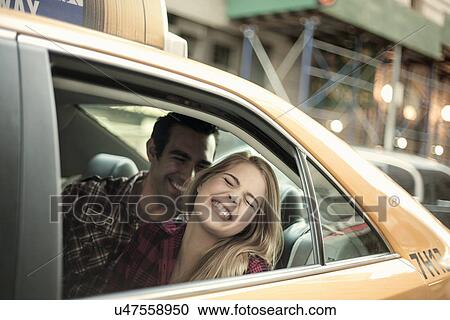 Young couple laughing in yellow cab, New York City, USA View Large Photo Image Stock Image - Young couple laughing in yellow cab, New York City, USA. Fotosearch