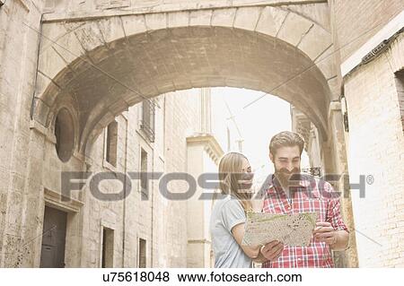 Young couple looking at map outside Valencia Cathedral, Valencia, Spain View Large Photo Image Stock Photo - Young couple looking at map outside Valencia Cathedral, Valencia, Spain. Fotosearch