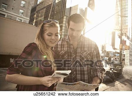 Young couple looking at maps, New York City, USA View Large Photo Image Stock Image - Young couple looking at maps, New York City, USA. Fotosearch