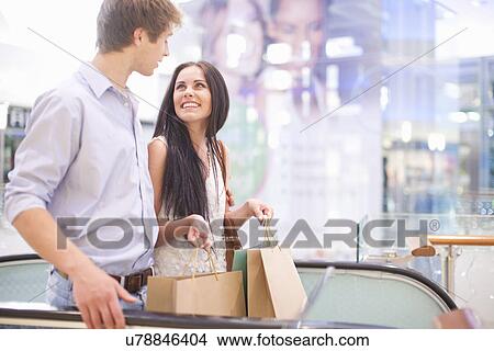 Young couple shopping in mall View Large Photo Image Picture - Young couple shopping in mall. Fotosearch