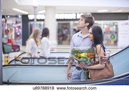 Young couple shopping in mall View Large Photo Image Stock Photo - Young couple shopping in mall. Fotosearch