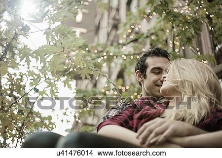 Picture - Young couple sitting on steps. Fotosearch