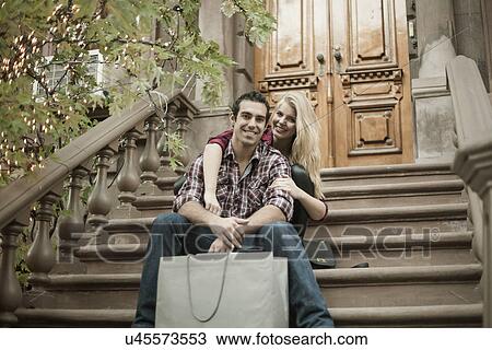 Young couple sitting on traditional city apartment steps View Large Photo Image Stock Image - Young couple sitting on traditional city apartment steps. Fotosearch