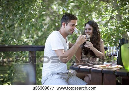 Young couple tasting wine at vineyard bar View Large Photo Image Stock Photo - Young couple tasting wine at vineyard bar. Fotosearch