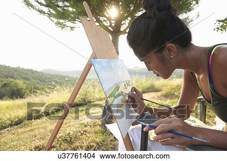Picture - Young female artist painting landscape, Buonconvento, Tuscany, Italy. Fotosearch