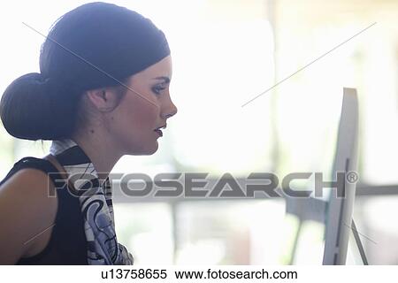 Young female office working on computer View Large Photo Image Stock Photography - Young female office working on computer. Fotosearch
