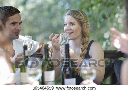 Young friends tasting and smelling wine at vineyard bar View Large Photo Image Stock Photo - Young friends tasting and smelling wine at vineyard bar. Fotosearch