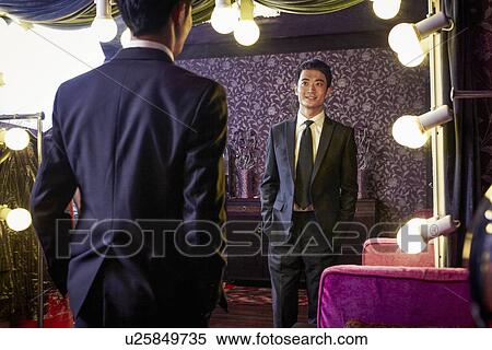 Young male client trying on new suit in traditional tailors shop View Large Photo Image Stock Photography - Young male client trying on new suit in traditional tailors shop. Fotosearch