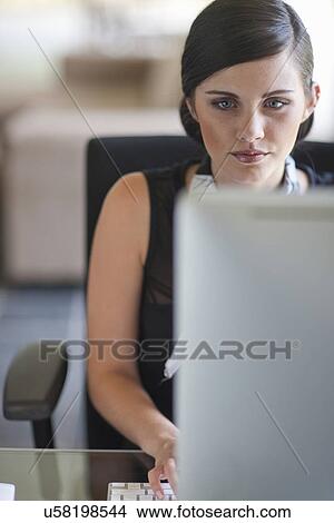 Young office worker using computer View Large Photo Image Picture - Young office worker using computer. Fotosearch