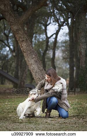 Young woman and dog in forest View Large Photo Image Stock Photo - Young woman and dog in forest. Fotosearch