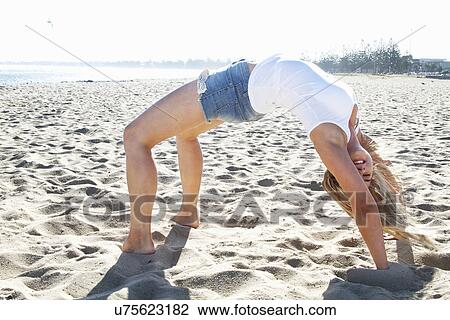 Young woman bending over backwards on beach, Melbourne, Victoria, Australia View Large Photo Image Stock Image - Young woman bending over backwards on beach, Melbourne, Victoria, Australia. Fotosearch