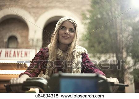 Stock Photography - Young woman cycling, New York City, USA. Fotosearch