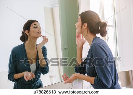 Young woman doing her beauty routine View Large Photo Image Stock Image - Young woman doing her beauty routine. Fotosearch