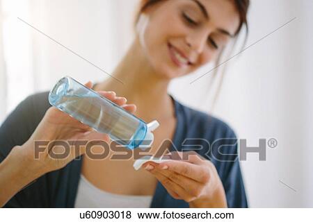 Stock Photo - Young woman doing her beauty routine. Fotosearch