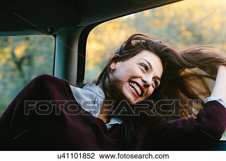 Young woman enjoying car ride View Large Photo Image Stock Image - Young woman enjoying car ride. Fotosearch