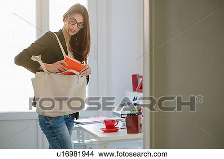 Young woman getting ready to go out View Large Photo Image Picture - Young woman getting ready to go out. Fotosearch