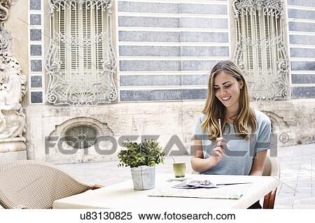 Young woman having a coffee outside Museum of Ceramics, Valencia, Spain View Large Photo Image Stock Photography - Young woman having a coffee outside Museum of Ceramics, Valencia, Spain. Fotosearch