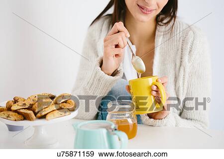 Young woman having honey drink View Large Photo Image Stock Photo - Young woman having honey drink. Fotosearch