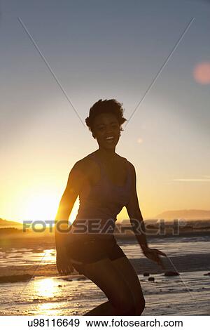Stock Photo - Young woman in bikini by seaside. Fotosearch