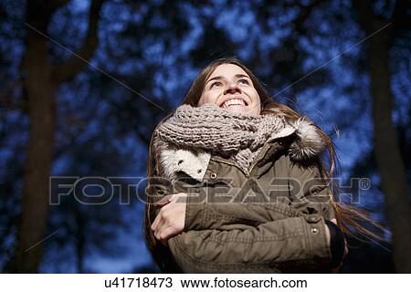 Young woman in forest at dusk View Large Photo Image Stock Image - Young woman in forest at dusk. Fotosearch