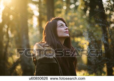 Young woman in the woods View Large Photo Image Stock Photograph - Young woman in the woods. Fotosearch