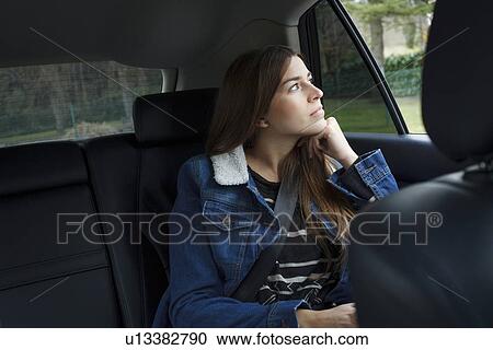 Young woman inside car View Large Photo Image Stock Image - Young woman inside car. Fotosearch