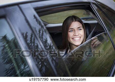 Young woman inside car View Large Photo Image Stock Image - Young woman inside car. Fotosearch