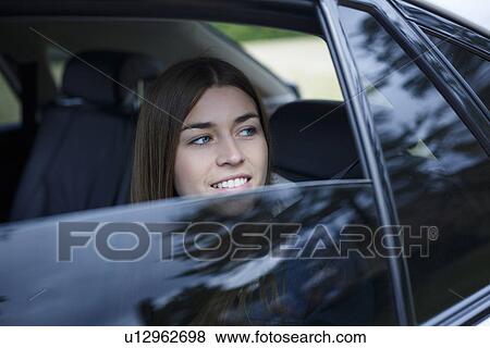 Young woman inside car View Large Photo Image Stock Photo - Young woman inside car. Fotosearch