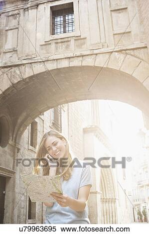 Young woman looking at map outside Valencia Cathedral, Valencia, Spain View Large Photo Image Stock Photography - Young woman looking at map outside Valencia Cathedral, Valencia, Spain. Fotosearch